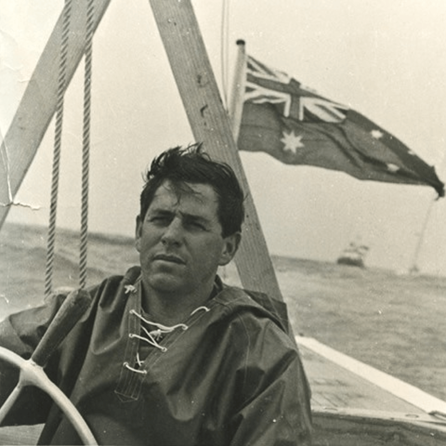 A historic image showing a man sailing.